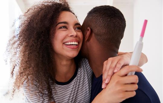 Couple Celebrating Positive Home Pregnancy Test Result