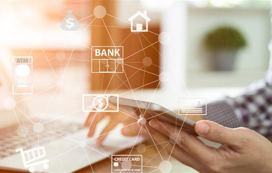 person mobile banking with smartphone and laptop