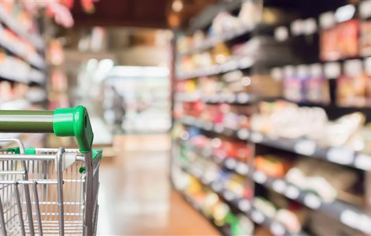gorcery cart in grocery store with blurry background
