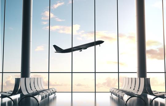 airplane taking off above empty airport lobby