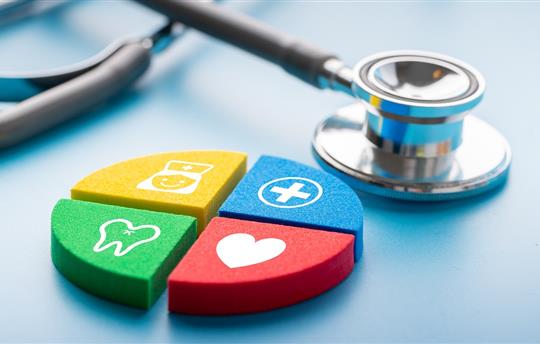 Medical icons on jigsaw puzzle next to stethoscope