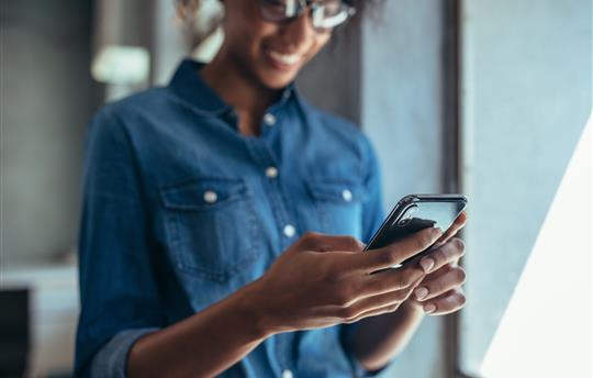 businessperson looking at her cell phone