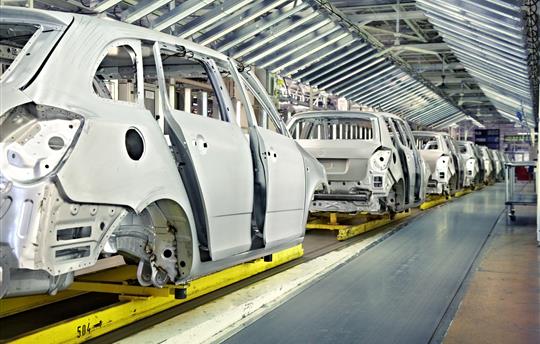 white cars being manufactured in a plant