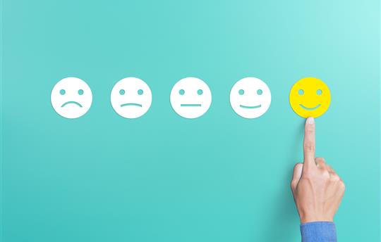 teal background with smiling faces indicating customer satisfaction