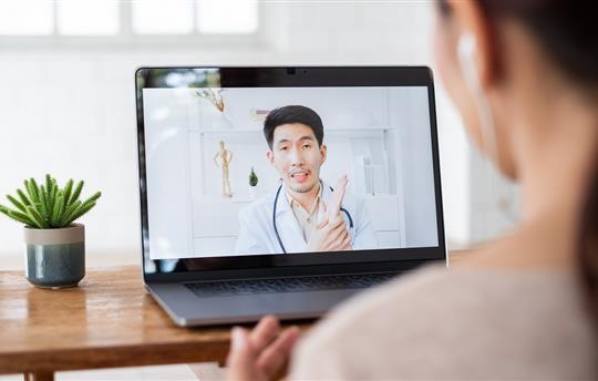 telehealth concept shows woman talking with doctor via computer laptop on a virtual video call