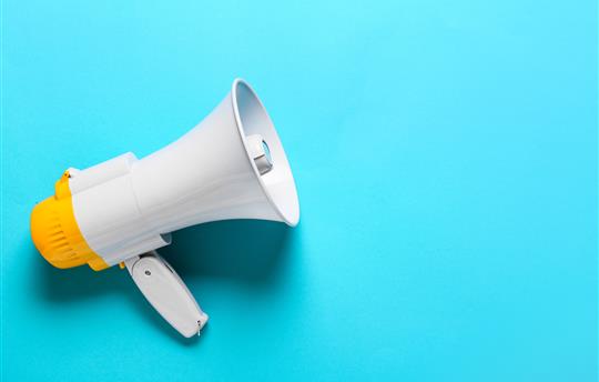 megaphone on bright blue background