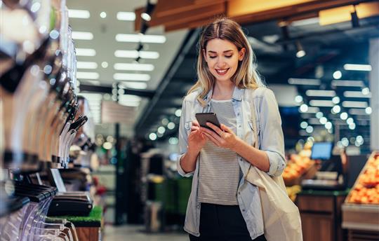 woman shopping looking at phone