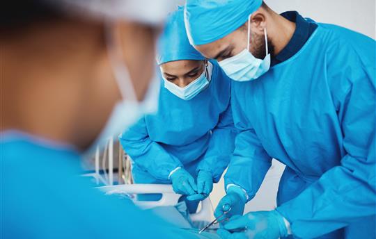 surgeons in PPE in a surgical unit