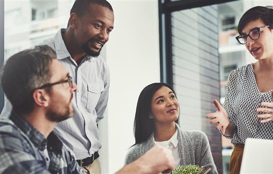 employees discussing a project at the office