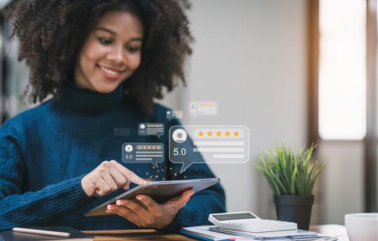 woman looking at reviews on tablet