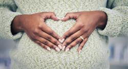 Pregnancy, closeup and woman with a heart shape on her maternal belly for care and motherhood