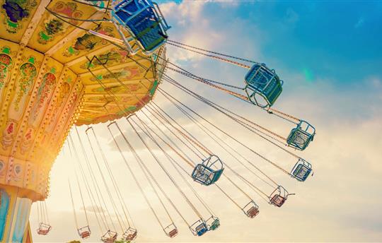 carousel ride spins fast in the air at sunset