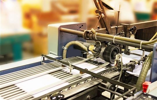 Pages being printed on printing press