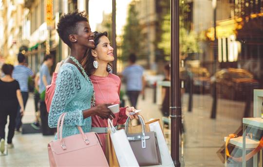 Female friends window shopping in the summer