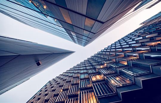 Looking directly up at the skyline of the financial district in central London