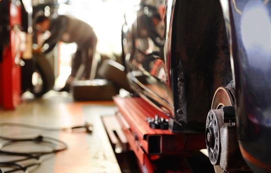 mechanic replacing tires on a car