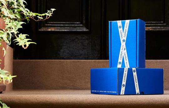 Blue packages produced by RRD sitting outside the front door of a house.