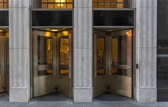 Nondescript entrance with revolving doors of urban building