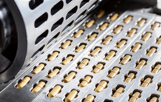 sheet of yellow pharmaceutical capsules