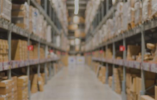 warehouse aisle filled with boxes and pallets