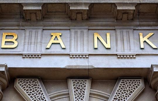 The word bank in gold on the front of a building