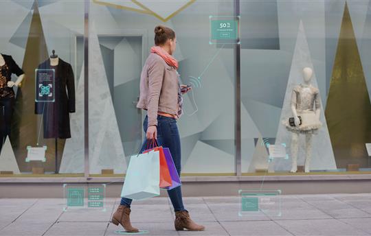 shopper walking passed a window display considering different products
